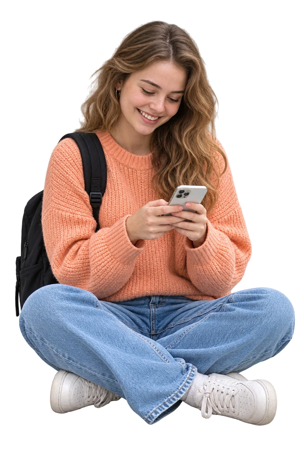 A learner smiling as she looks at her phone