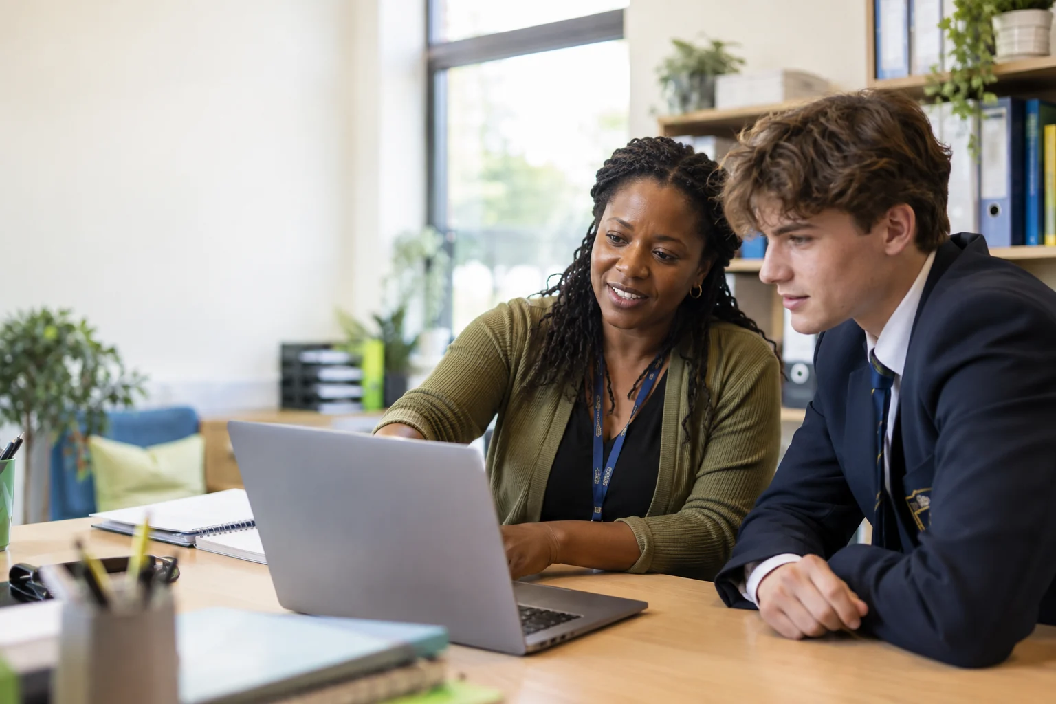School registrar reviewing a record with a senior student